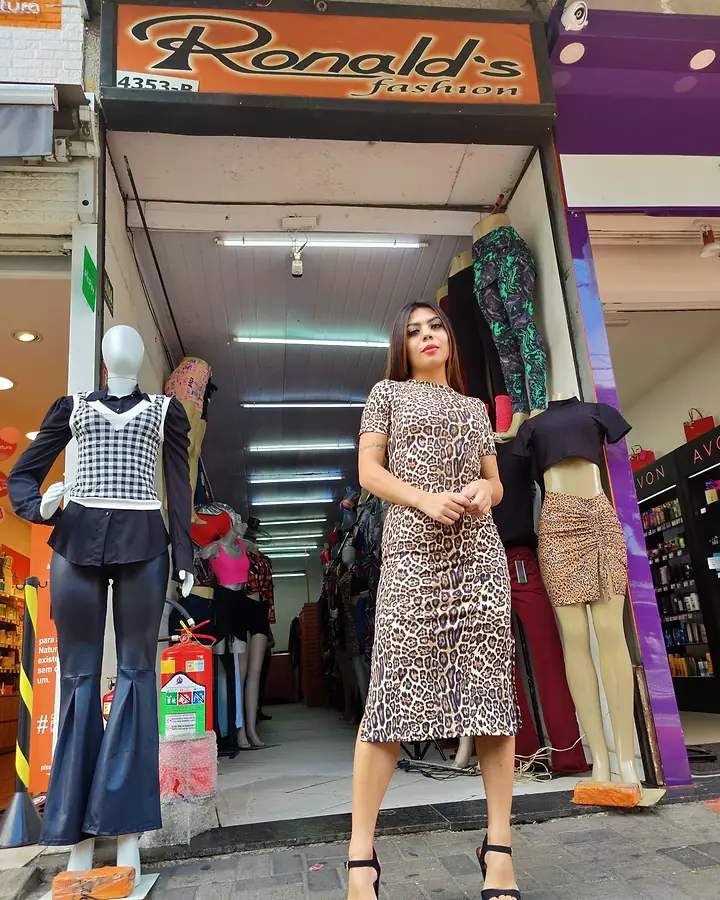 Modelo de vestido midi de estampa de onça na porta da Ronald's Fashion